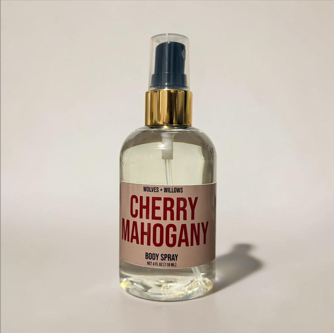 Body spray bottle labeled 'Cherry Mahogany' by Wolves & Willows on a light background