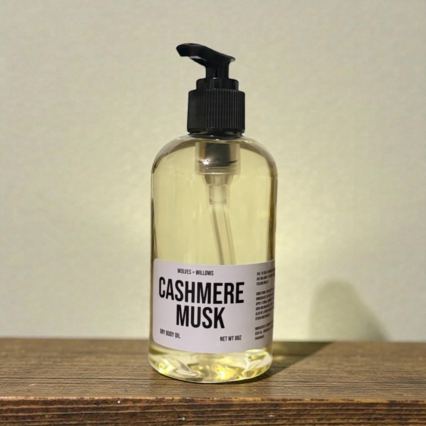 8 ounce 'Cashmere Musk' body oil in clear bottle with black pump.