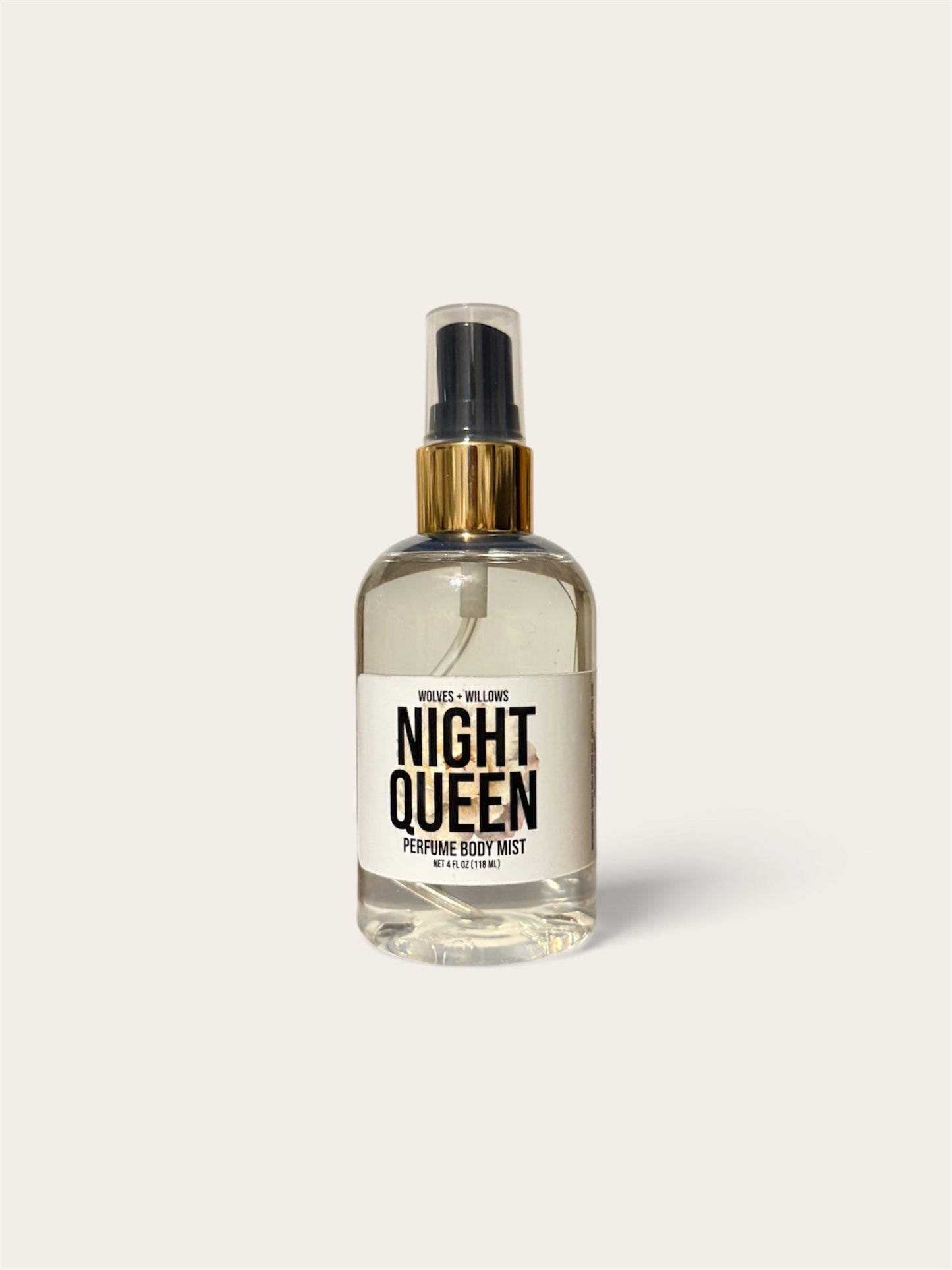A clear glass perfume body mist bottle with a white label reading 'NIGHT QUEEN' and a gold spray collar, centered on a light warm gray background.