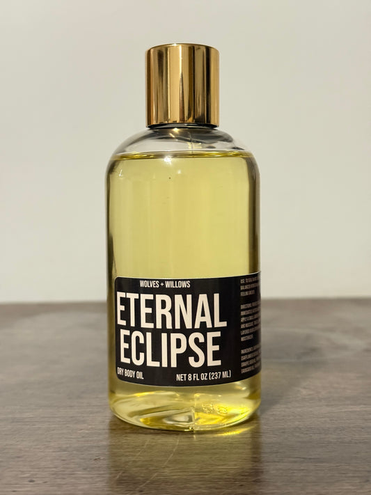 Bottle of 'Eternal Eclipse' with a gold cap on a neutral background