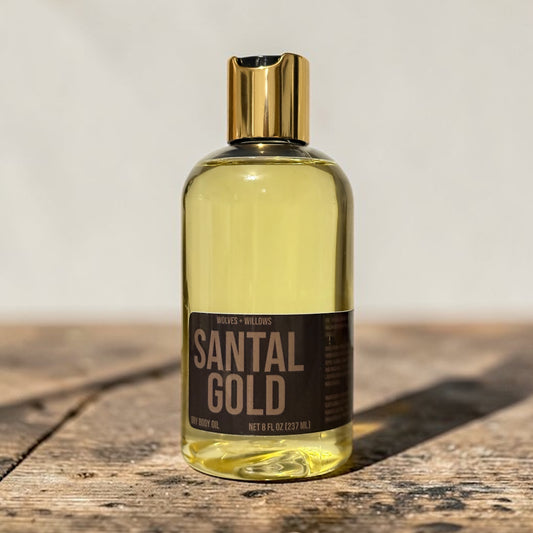 Bottle of Santal Gold on a wooden surface with a neutral background