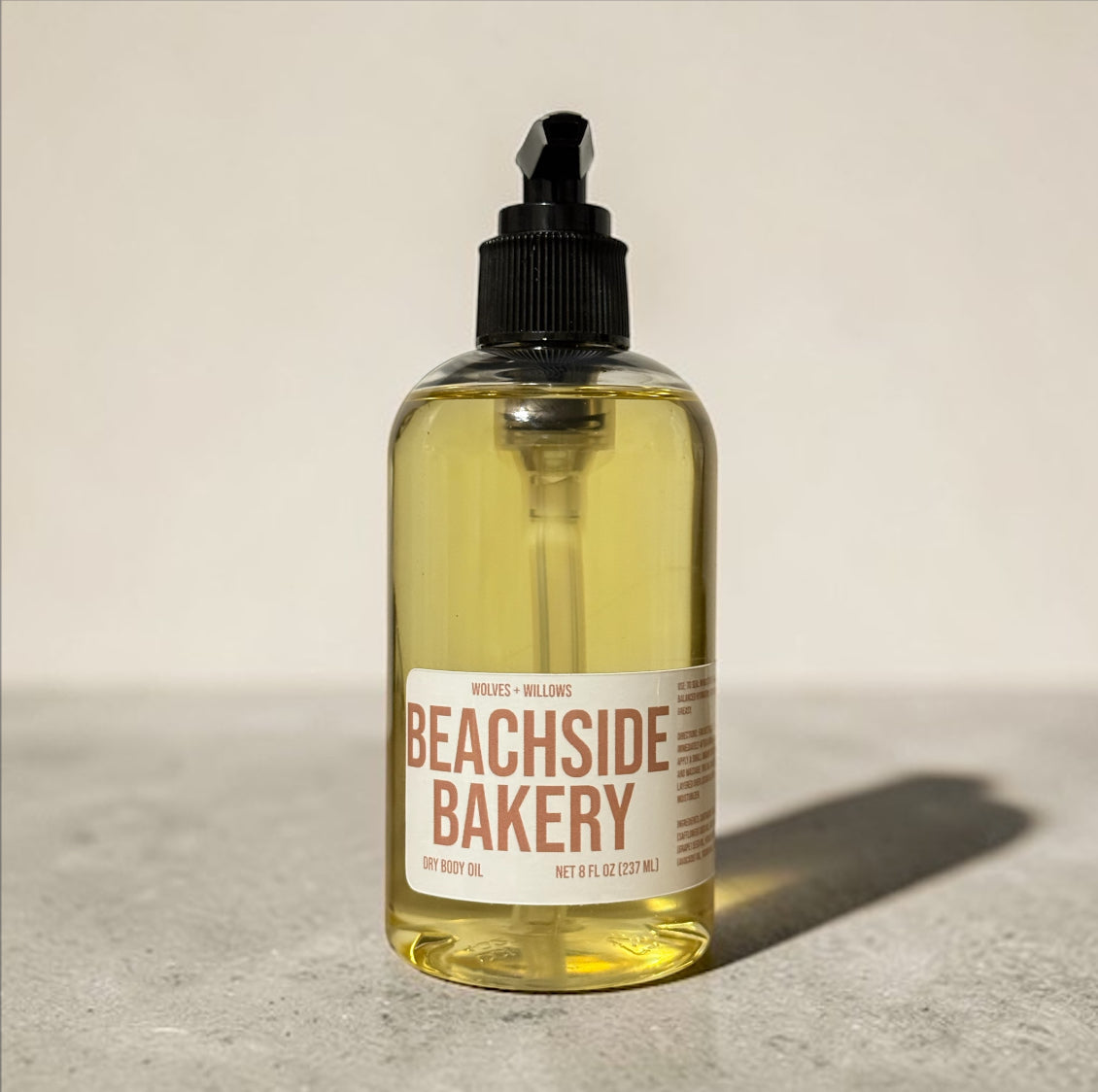Bottle of Beachside Bakery body oil on a neutral background