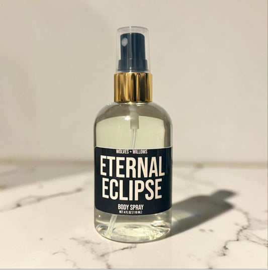 Body spray bottle labeled 'Eternal Eclipse' on a marble surface with a neutral background