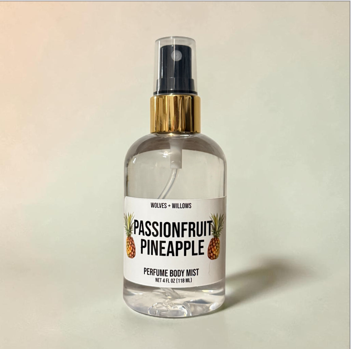 Passionfruit pineapple perfume body mist bottle on a beige background