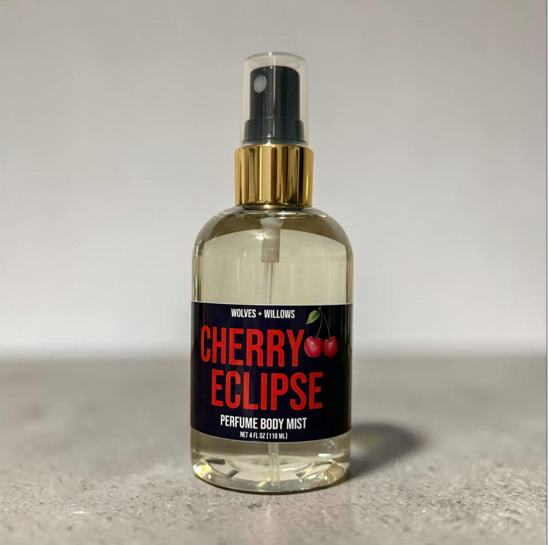 Perfume body mist bottle labeled 'Cherry Eclipse' by Wolves & Willows on a neutral background