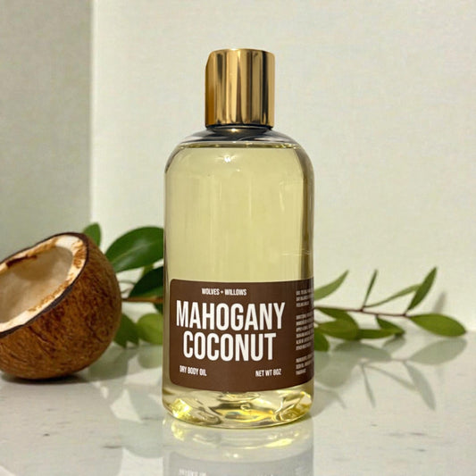 Mahogany Coconut 8 ounce body oil in clear bottle with gold dispensing cap.