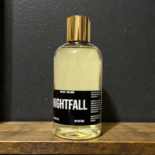 Bottle of 'Nightfall' on a wooden surface with a dark background