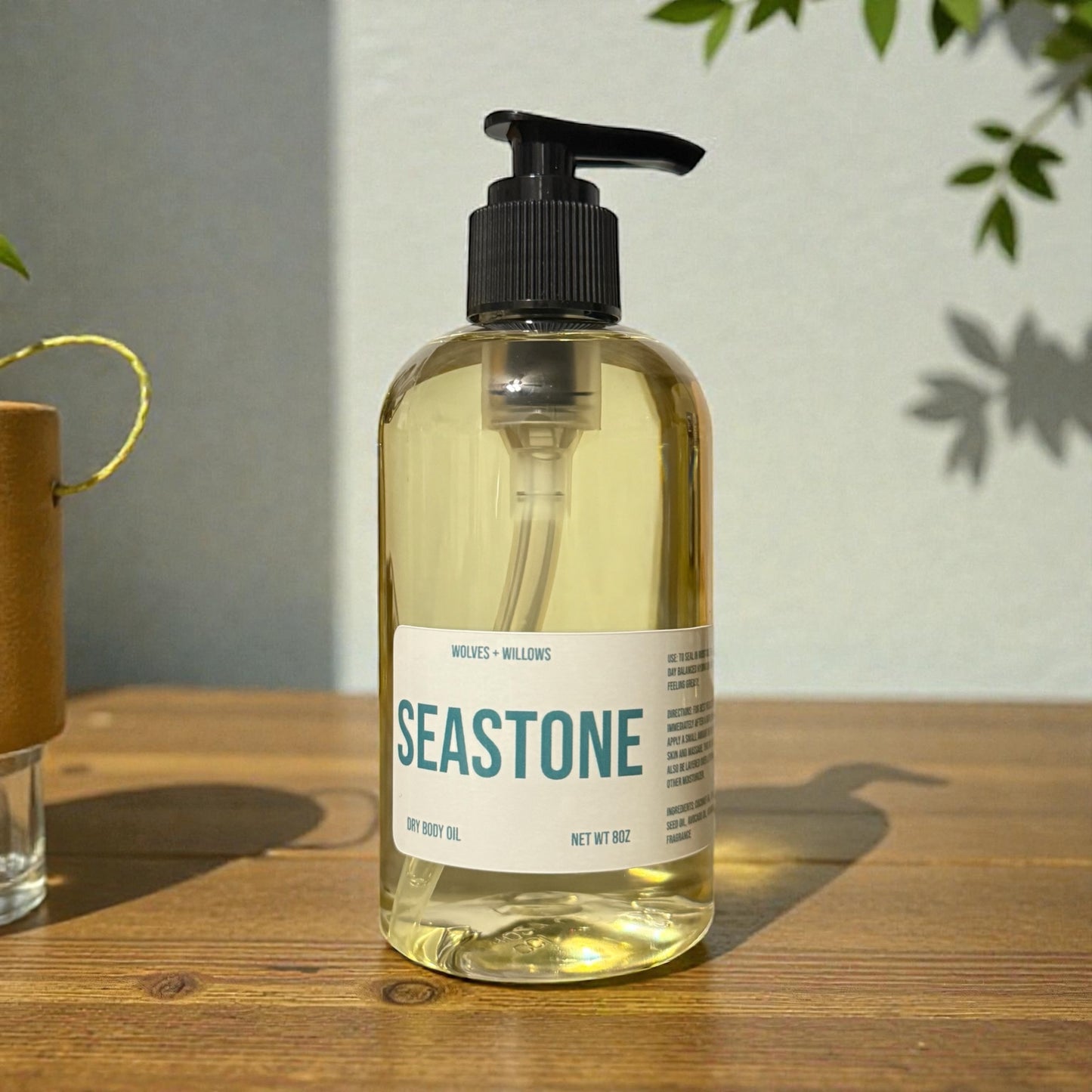Bottle of Seastone product on a wooden surface with a plant in the background