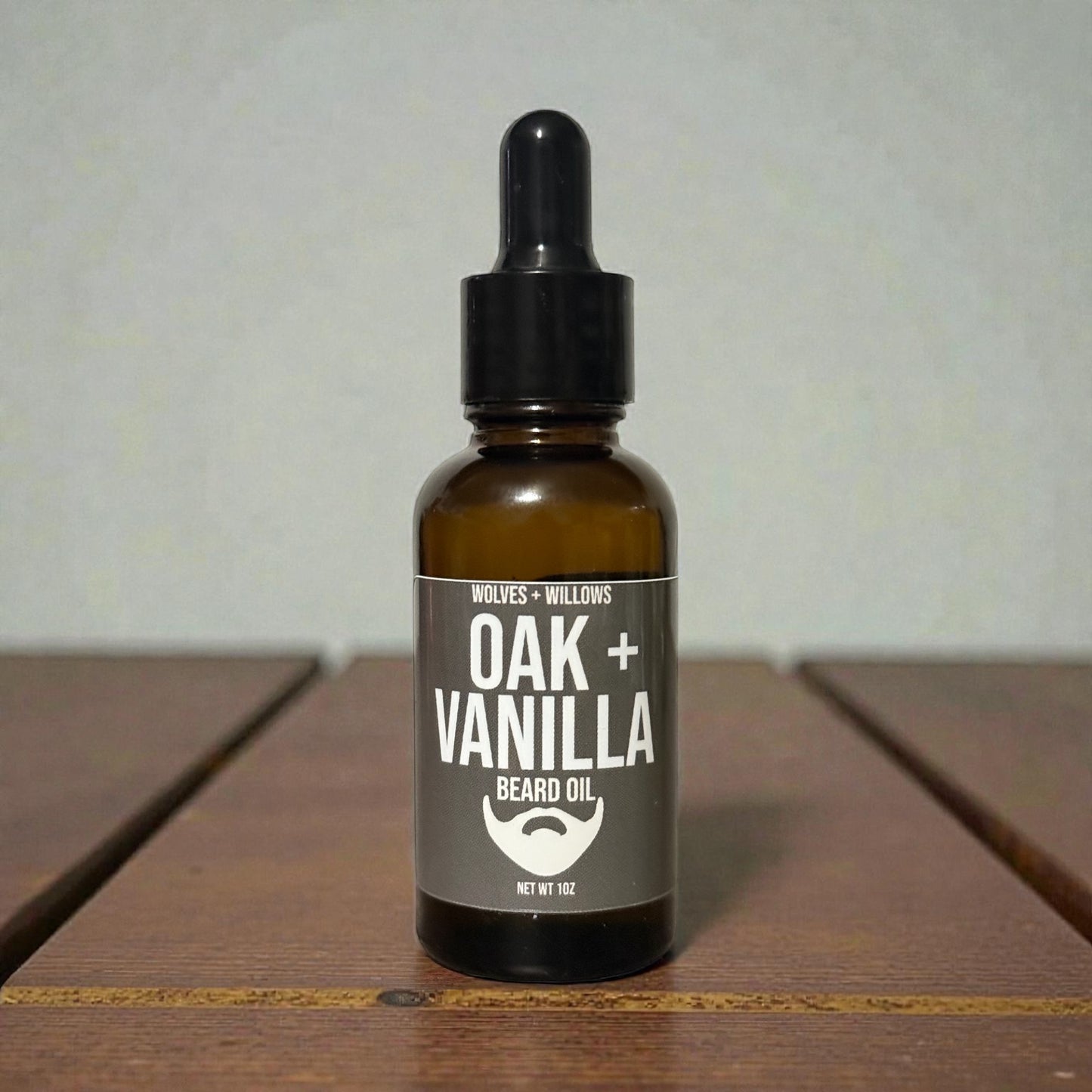 Bottle of Oak Vanilla beard oil on a wooden surface with a neutral background