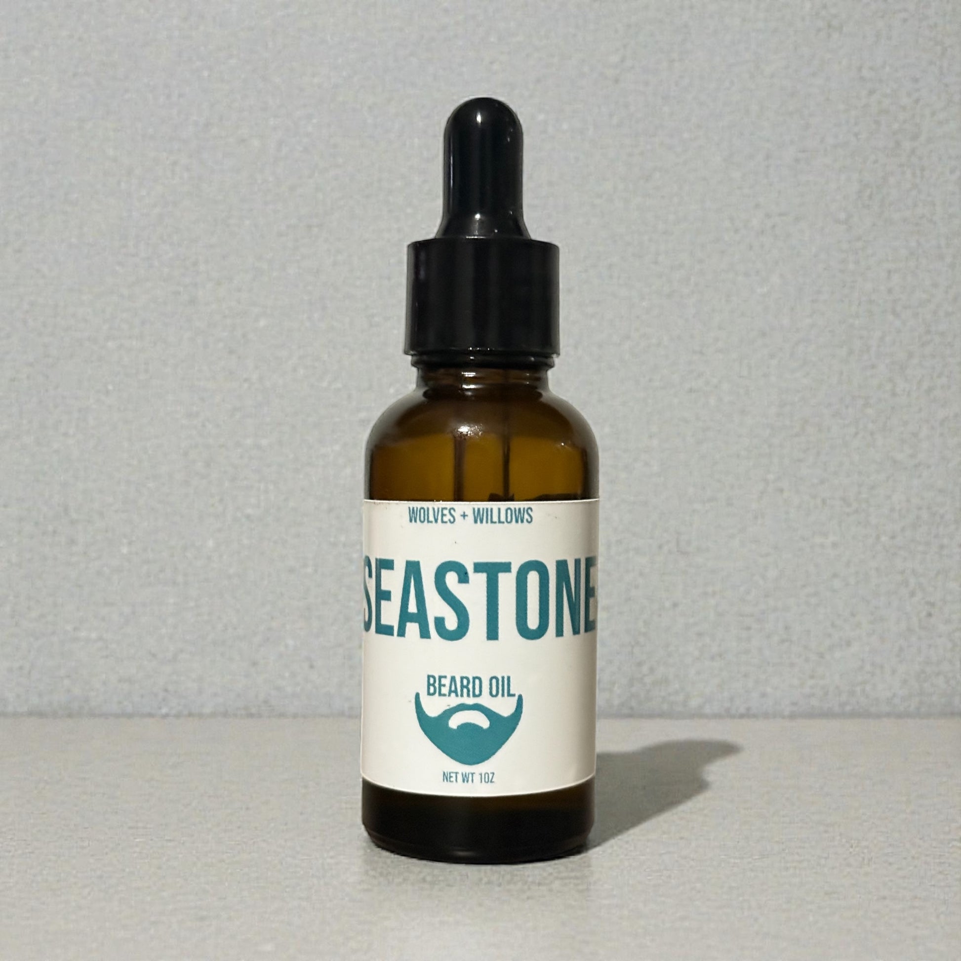 Bottle of Seastone beard oil with a label on a gray background