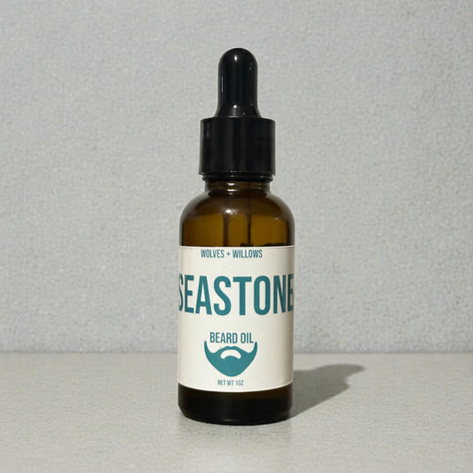 Bottle of Seastone beard oil with a label on a gray background