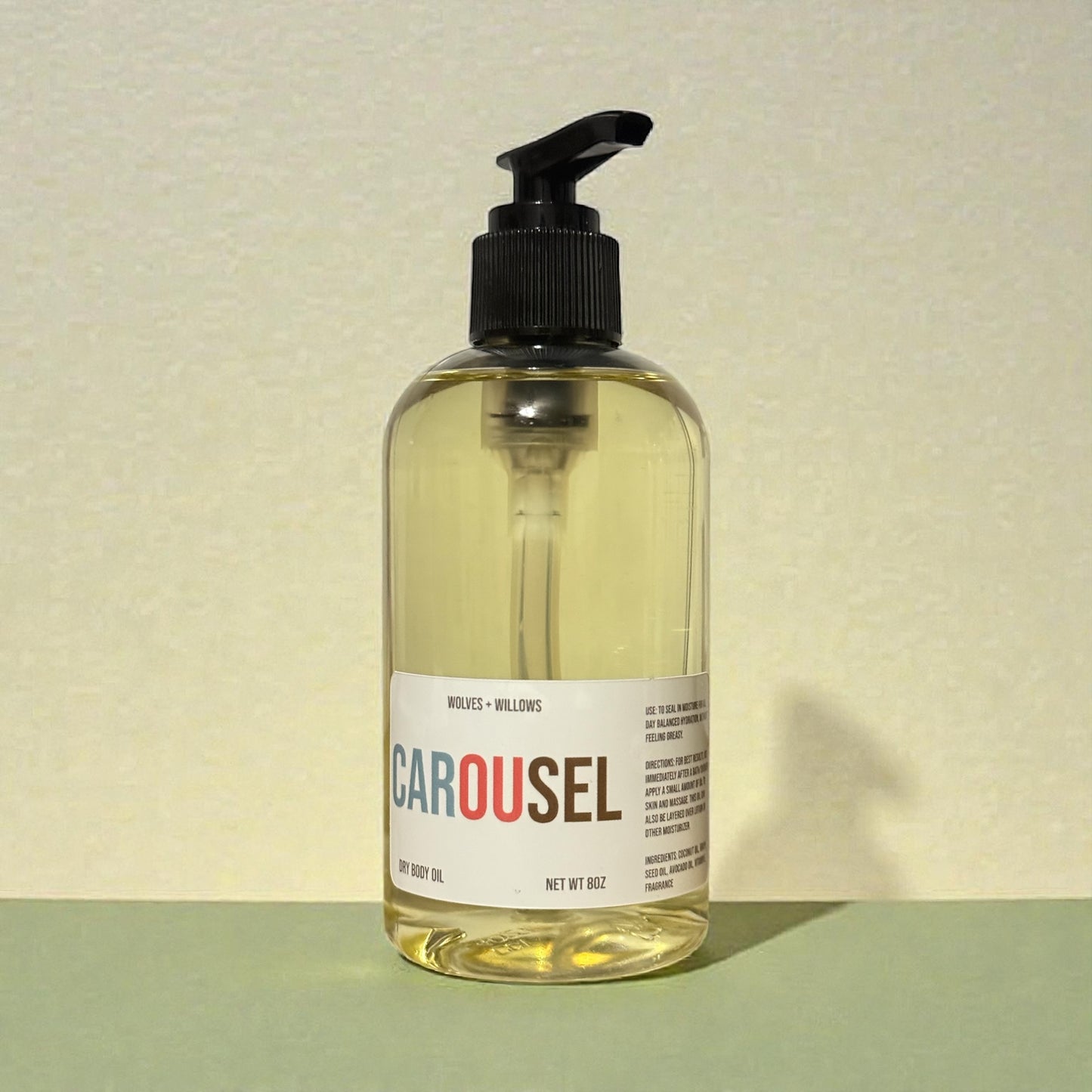 Bottle of Carousel body wash with pump on a light background