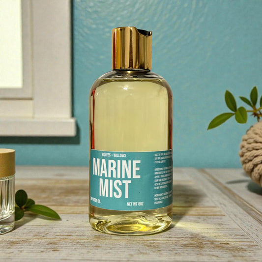 Bottle of 'Marine Mist' body wash on a wooden surface with a blue wall in the background.