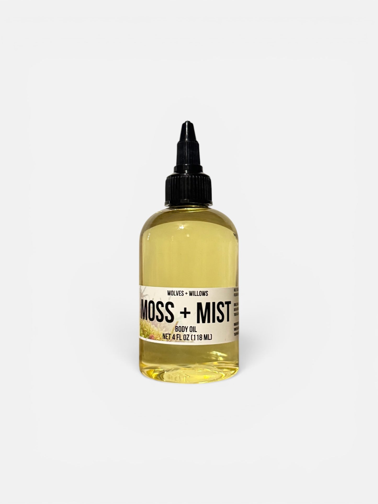 Bottle of Moss + Mist body oil on a white background