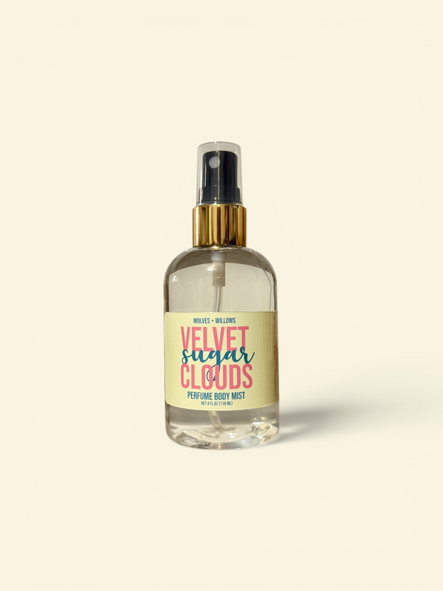 Perfume bottle labeled 'Velvet Sugar Clouds' on a beige background