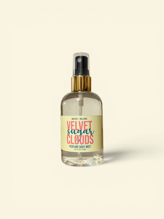 Perfume bottle labeled 'Velvet Sugar Clouds' on a beige background