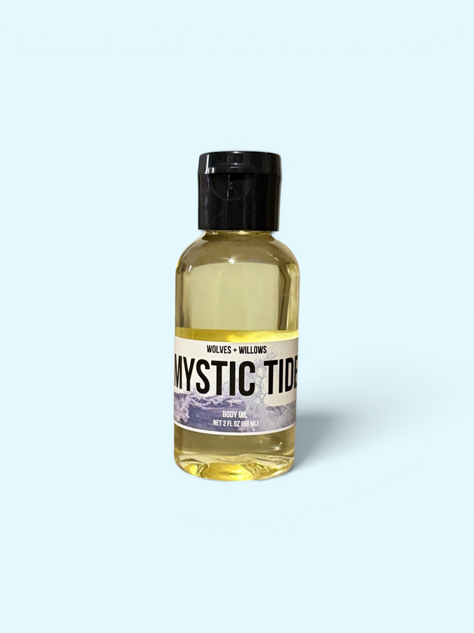 Bottle of 'Mystic Tide' body oil with a black cap on a white background