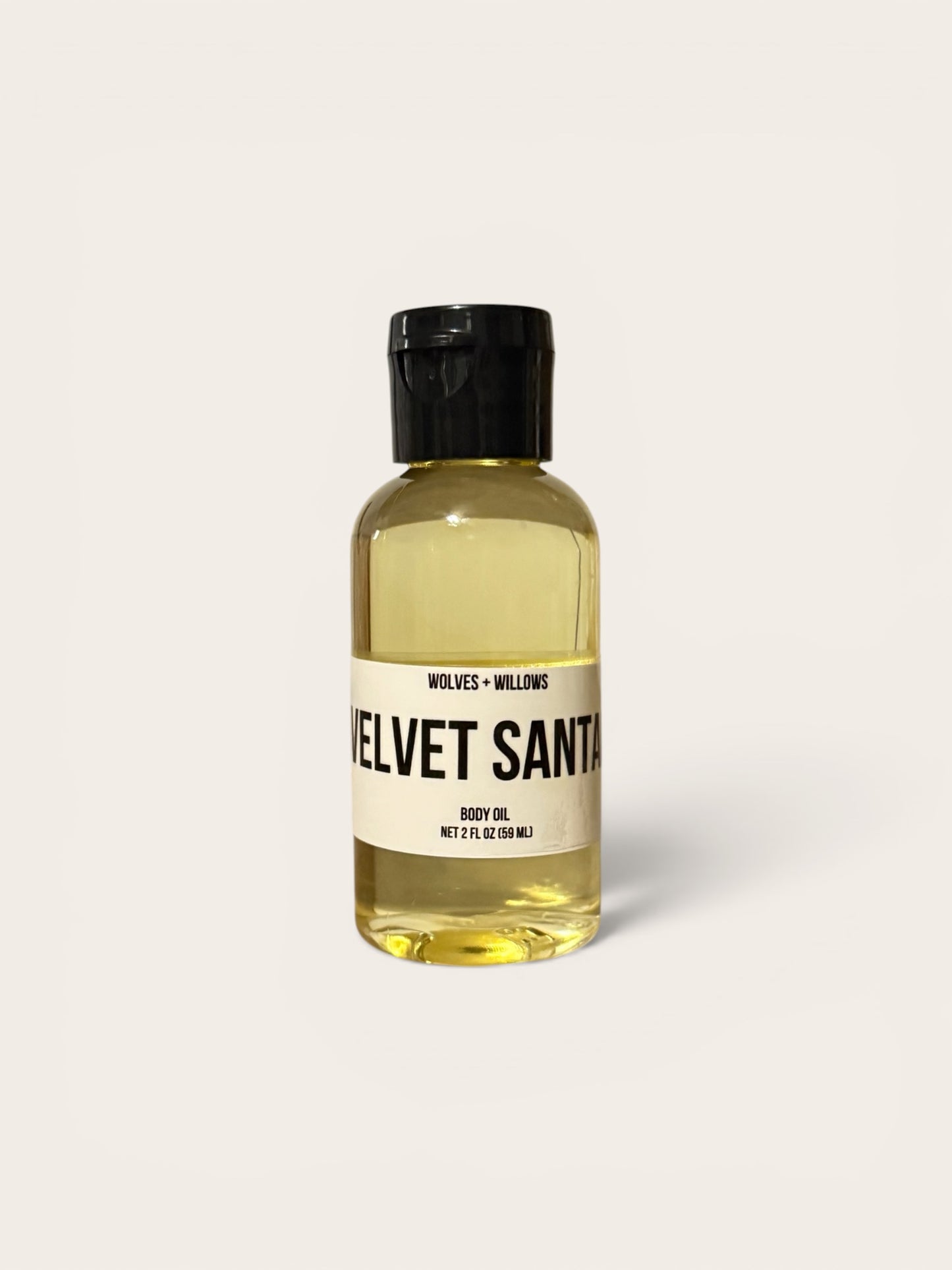 Bottle of 'Velvet Santa' body oil on a white background