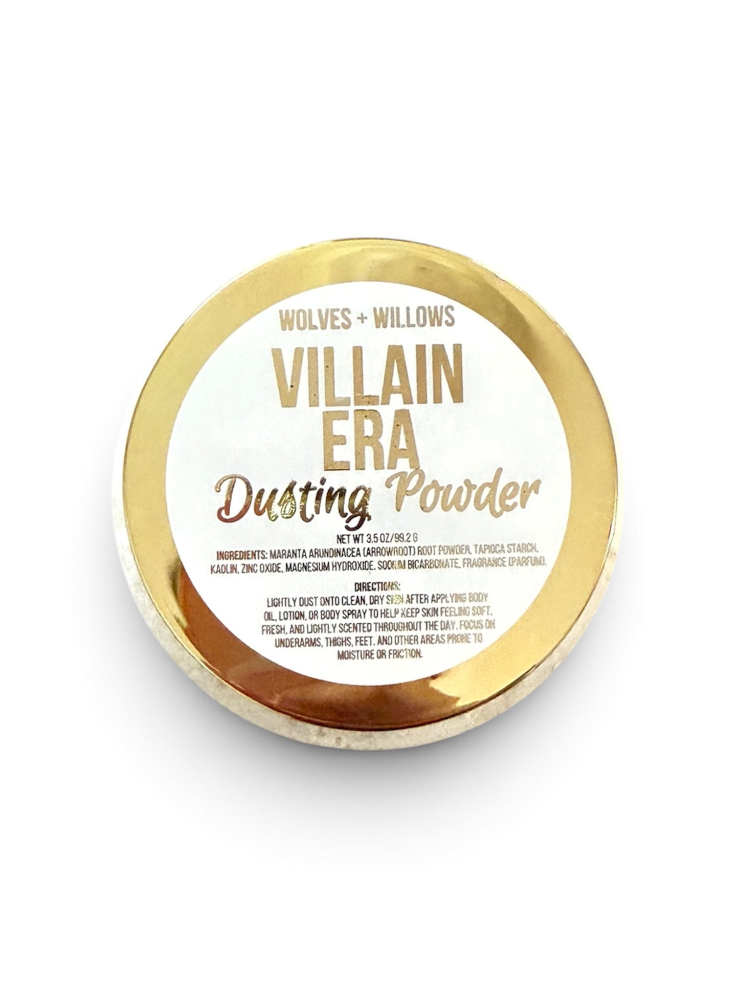 A round gold-labeled container of Wolves + Willows 'Villain Era' Dusting Powder on a clean white background.